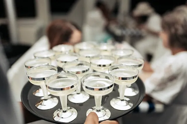 A tray of sparkling drinks being served on board