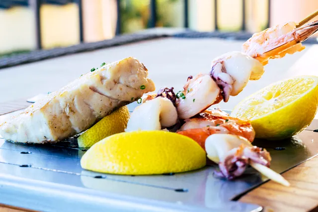 Seafood skewers served with lemon