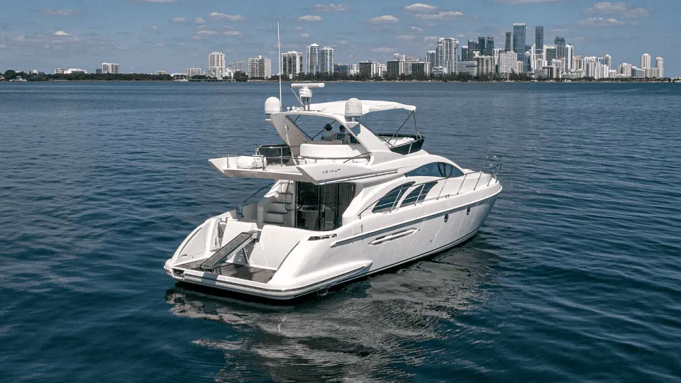 The Azimut 58 Fly cruising with the city skyline behind
