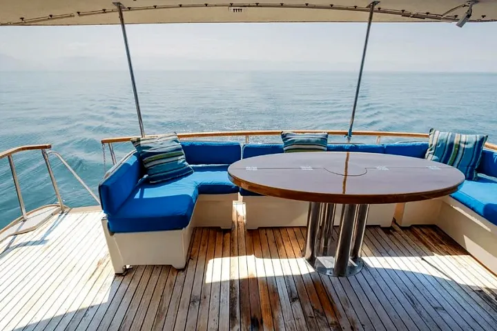 Aft deck seating with a table aboard the Hatteras 61