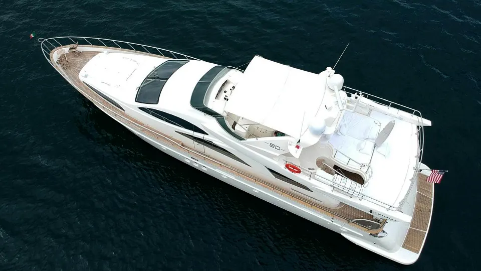 Aerial view of a flybridge superyacht cruising deep blue water